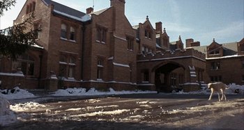 Movie still from “Alice's Restaurant” (1969), directed by Arthur Penn – An old brick building with snow on the ground; Extreme Wide shot, Low angle
