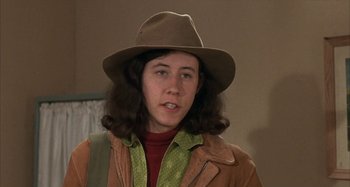 Movie still from “Alice's Restaurant” (1969), directed by Arthur Penn – A woman wearing a brown hat and a green jacket; Close Up shot, High angle