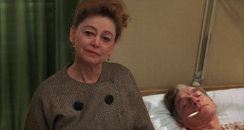 Movie still from “Alice's Restaurant” (1969), directed by Arthur Penn – An older woman sitting in front of an older man in bed; Close Up shot, Over the shoulder angle