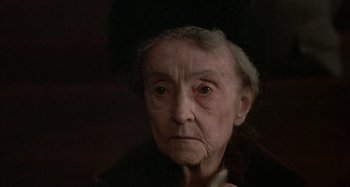 Movie still from “Alice's Restaurant” (1969), directed by Arthur Penn – An old woman wearing a hat and looking at the camera; Close Up shot, High angle