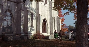 Movie still from “Alice's Restaurant” (1969), directed by Arthur Penn – Two people walking in front of an old white church; Extreme Wide shot, Low angle