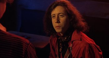 Movie still from “Alice's Restaurant” (1969), directed by Arthur Penn – A man with long red hair wearing a red jacket; Close Up shot, Low angle