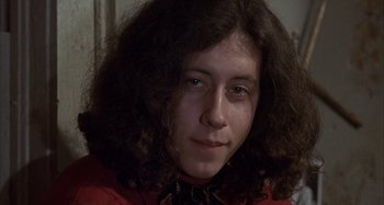 Movie still from “Alice's Restaurant” (1969), directed by Arthur Penn – A woman with long brown hair wearing a red shirt; Close Up shot, Low angle