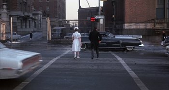 Movie still from “Alice's Restaurant” (1969), directed by Arthur Penn – A man and a woman walking across a street; Wide shot, High angle