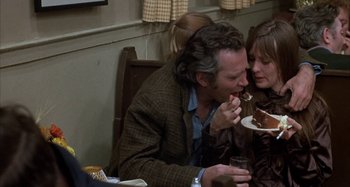 Movie still from “Alice's Restaurant” (1969), directed by Arthur Penn – A man and a woman sharing a piece of cake; Medium shot, Over the shoulder angle