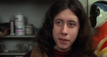 Movie still from “Alice's Restaurant” (1969), directed by Arthur Penn – A person with long black hair; Close Up shot, Low angle