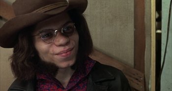 Movie still from “Alice's Restaurant” (1969), directed by Arthur Penn – A person wearing glasses and a cowboy hat; Close Up shot, High angle