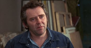 Movie still from “Alice's Restaurant” (1969), directed by Arthur Penn – A person wearing a jean jacket; Close Up shot, Over the shoulder angle