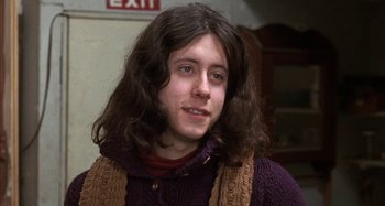 Movie still from “Alice's Restaurant” (1969), directed by Arthur Penn – A young man with long hair and a scarf; Close Up shot, Low angle