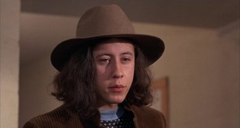 Movie still from “Alice's Restaurant” (1969), directed by Arthur Penn – A young man wearing a brown hat and a jacket; Close Up shot, Low angle