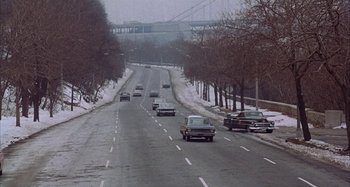 Movie still from “Alice's Restaurant” (1969), directed by Arthur Penn – Cars driving down a road in the snow; Extreme Wide shot, High angle