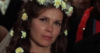 Movie still from “Alice's Restaurant” (1969), directed by Arthur Penn – A person wearing a wreath of flowers; Close Up shot, Low angle