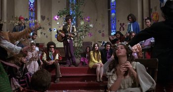 Movie still from “Alice's Restaurant” (1969), directed by Arthur Penn – A group of young people sitting on some steps; Wide shot, Low angle