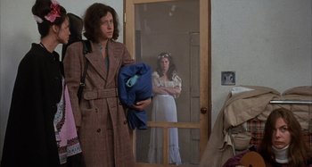 Movie still from “Alice's Restaurant” (1969), directed by Arthur Penn – A woman standing in front of a screen door; Medium shot, Over the shoulder angle