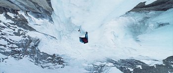 Movie still from “Alien vs. Predator” (2004), directed by Paul W.S. Anderson – A man flying through the air while riding a snow board; Extreme Wide shot, Overhead angle