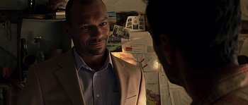 Movie still from “Alien vs. Predator” (2004), directed by Paul W.S. Anderson – A man wearing a suit and tie talking to another man in a suit; Close Up shot, Over the shoulder angle