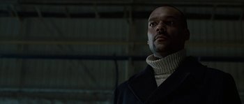 Movie still from “Alien vs. Predator” (2004), directed by Paul W.S. Anderson – A man wearing a black coat and a white sweater; Close Up shot, Low angle