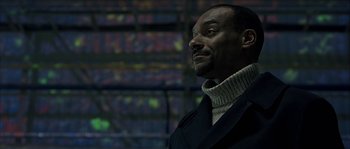 Movie still from “Alien vs. Predator” (2004), directed by Paul W.S. Anderson – A man in a black coat and a white sweater; Close Up shot, Low angle