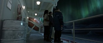 Movie still from “Alien vs. Predator” (2004), directed by Paul W.S. Anderson – A group of people standing next to each other on a dock; Wide shot, High angle