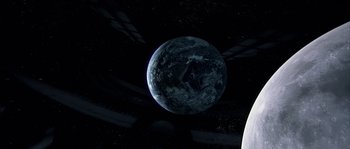 Movie still from “Alien vs. Predator” (2004), directed by Paul W.S. Anderson – An image of an earth in the dark sky; Extreme Wide shot, Overhead angle