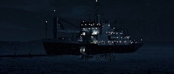 Movie still from “Alien vs. Predator” (2004), directed by Paul W.S. Anderson – A large ship in the dark with lights on it; Extreme Wide shot, High angle