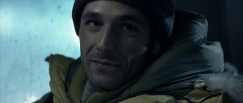 Movie still from “Alien vs. Predator” (2004), directed by Paul W.S. Anderson – A person wearing a jacket and a hat; Close Up shot, Low angle