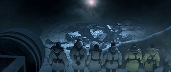 Movie still from “Alien vs. Predator” (2004), directed by Paul W.S. Anderson – A group of men standing in front of a destroyed building; Extreme Wide shot, High angle