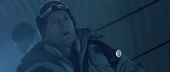 Movie still from “Alien vs. Predator” (2004), directed by Paul W.S. Anderson – A man wearing a ski jacket and a helmet; Close Up shot, Low angle