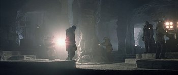 Movie still from “Alien vs. Predator” (2004), directed by Paul W.S. Anderson – Two people standing in front of an ice cave at night; Extreme Wide shot, Low angle