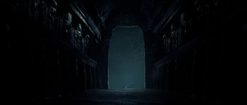 Movie still from “Alien vs. Predator” (2004), directed by Paul W.S. Anderson – An empty dark room with a large arch; Extreme Wide shot, High angle