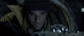 Movie still from “Alien vs. Predator” (2004), directed by Paul W.S. Anderson – A person wearing a jacket and a hat; Close Up shot, Overhead angle