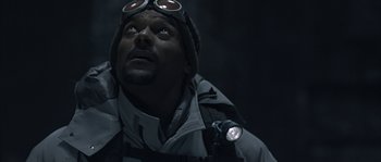 Movie still from “Alien vs. Predator” (2004), directed by Paul W.S. Anderson – A man wearing goggles looking up into the sky; Close Up shot, Low angle