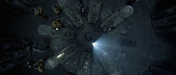 Movie still from “Alien vs. Predator” (2004), directed by Paul W.S. Anderson – Looking down at a group of statues in a building; Extreme Wide shot, Overhead angle