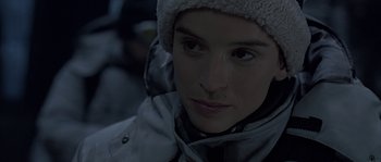 Movie still from “Alien vs. Predator” (2004), directed by Paul W.S. Anderson – A person wearing a jacket and a hat; Close Up shot, Over the shoulder angle