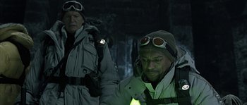 Movie still from “Alien vs. Predator” (2004), directed by Paul W.S. Anderson – A man in a white jacket and a man in a green jacket; Medium shot, Over the shoulder angle