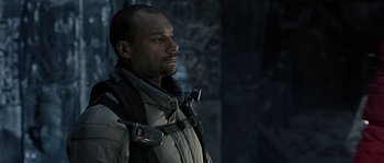 Movie still from “Alien vs. Predator” (2004), directed by Paul W.S. Anderson – A man with a beard wearing a jacket and a helmet; Close Up shot, Low angle