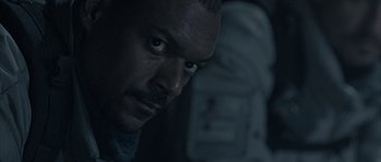 Movie still from “Alien vs. Predator” (2004), directed by Paul W.S. Anderson – A man's face in the dark; Close Up shot, Low angle