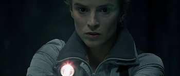 Movie still from “Alien vs. Predator” (2004), directed by Paul W.S. Anderson – A woman is holding a flashlight in her hand; Close Up shot, High angle