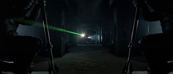 Movie still from “Alien vs. Predator” (2004), directed by Paul W.S. Anderson – A beam of light shining in a dark room; Extreme Wide shot, High angle