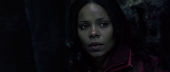 Movie still from “Alien vs. Predator” (2004), directed by Paul W.S. Anderson – A woman is looking at the camera while wearing a red jacket; Close Up shot, Low angle