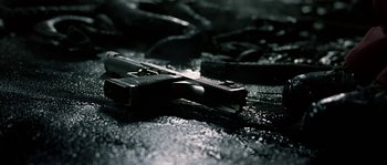 Movie still from “Alien vs. Predator” (2004), directed by Paul W.S. Anderson – A gun laying on the ground; Extreme Close Up shot, High angle