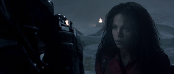 Movie still from “Alien vs. Predator” (2004), directed by Paul W.S. Anderson – A woman standing in front of a body of water at night; Close Up shot, Over the shoulder angle