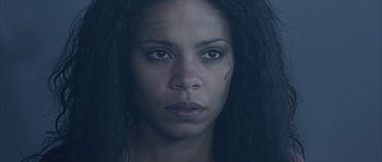 Movie still from “Alien vs. Predator” (2004), directed by Paul W.S. Anderson – A person with long black hair; Close Up shot, Low angle