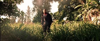 Movie still from “All About the Benjamins” (2002), directed by Kevin Bray – A man standing in a field with trees in the background; Wide shot, Low angle