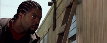 Movie still from “All About the Benjamins” (2002), directed by Kevin Bray – A person looking at the camera; Close Up shot, Low angle