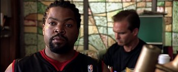 Movie still from “All About the Benjamins” (2002), directed by Kevin Bray – A man with a beard and a basketball jersey on; Close Up shot, Low angle