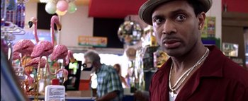 Movie still from “All About the Benjamins” (2002), directed by Kevin Bray – A person wearing a hat; Close Up shot, Over the shoulder angle