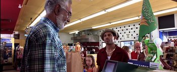 Movie still from “All About the Benjamins” (2002), directed by Kevin Bray – A man is standing in front of a woman and a child; Medium shot, Over the shoulder angle