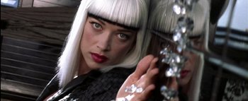 Movie still from “All About the Benjamins” (2002), directed by Kevin Bray – A person holding a umbrella; Close Up shot, Over the shoulder angle