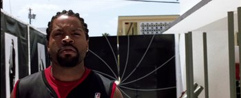 Movie still from “All About the Benjamins” (2002), directed by Kevin Bray – A person with a basketball hoop in the background; Close Up shot, Low angle